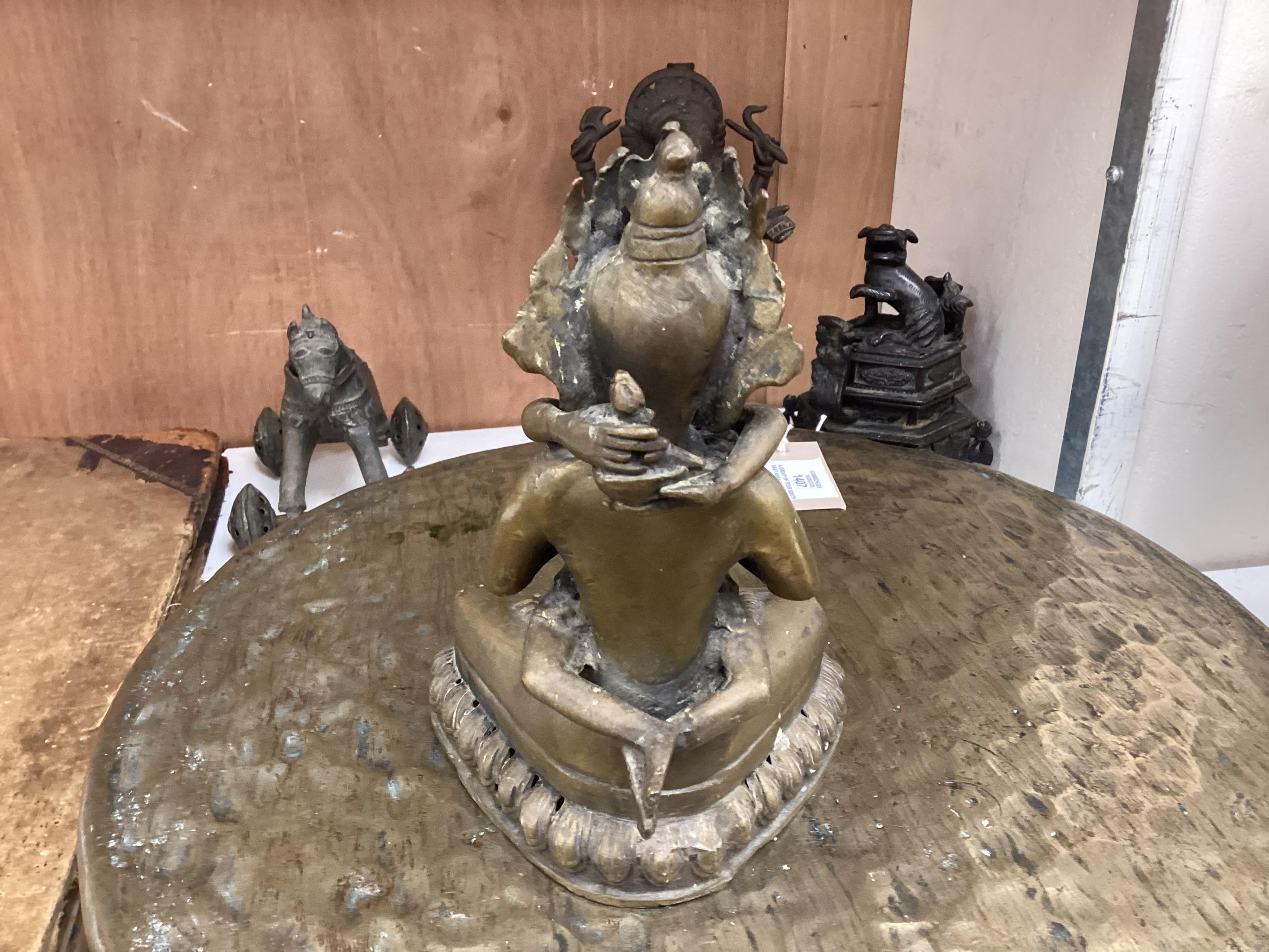 A group of four south east Asian cast bronzes and a gong with mount and beater, 40.5cm